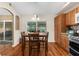 Charming dining area with hardwood floors, natural light, and a view of the enclosed patio at 13444 English Parrot Rd, Brooksville, FL 34614