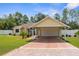 Inviting single-Gathering home with a carport, brick-paved driveway, landscaping, and a welcoming entrance at 13444 English Parrot Rd, Brooksville, FL 34614