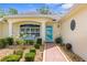 Inviting front entrance with landscaped garden and blue front door at 13444 English Parrot Rd, Brooksville, FL 34614