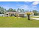 Charming single-story home with a well-manicured lawn, carport and a neatly landscaped front yard at 13444 English Parrot Rd, Brooksville, FL 34614