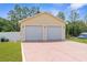 A detached two-car garage with painted driveway and manicured grass at 13444 English Parrot Rd, Brooksville, FL 34614