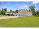 A detached two-car garage with a long driveway and green grass at 13444 English Parrot Rd, Brooksville, FL 34614