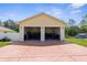 A detached garage with two bays and a red driveway at 13444 English Parrot Rd, Brooksville, FL 34614