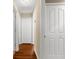 Hallway with clean white doors and wood floors at 13444 English Parrot Rd, Brooksville, FL 34614