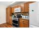 Well-equipped kitchen with stainless steel appliances, wood cabinets, and granite countertops at 13444 English Parrot Rd, Brooksville, FL 34614