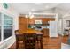 A kitchen with a wooden table, wooden cabinets, and modern appliances at 13444 English Parrot Rd, Brooksville, FL 34614