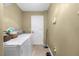 Functional laundry room with washer, dryer, and ample space for organization and cleaning supplies at 13444 English Parrot Rd, Brooksville, FL 34614