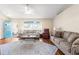 Bright living room with neutral sofas and a large window, offering ample seating at 13444 English Parrot Rd, Brooksville, FL 34614