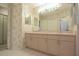 Bathroom featuring a double sink vanity, large mirrors, and soft lighting for a relaxing atmosphere at 14112 Whitecap Ave, Hudson, FL 34667