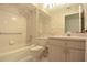 Traditional bathroom with a combination tub and shower, patterned wallpaper, and vanity at 14112 Whitecap Ave, Hudson, FL 34667