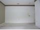 Unfurnished bedroom with neutral carpet, trim wallpaper, and access to a door at 14112 Whitecap Ave, Hudson, FL 34667