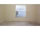 This bedroom has a window with blinds, a ceiling fan, and neutral walls for easy personalization at 14112 Whitecap Ave, Hudson, FL 34667