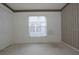 Vacant bedroom features wallpaper trim, a window with a view, and a spacious closet at 14112 Whitecap Ave, Hudson, FL 34667