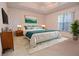 This bedroom features a large bed, stylish decor, and ample natural light from the window at 14112 Whitecap Ave, Hudson, FL 34667