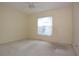 This bedroom features neutral walls, carpeted floors, and a window that offers plenty of natural light at 14112 Whitecap Ave, Hudson, FL 34667