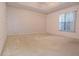 This bedroom boasts a tray ceiling, wallpaper, and a large window for plenty of natural light at 14112 Whitecap Ave, Hudson, FL 34667