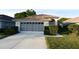 Single-story home with a two-car garage, neat landscaping, and inviting curb appeal at 14112 Whitecap Ave, Hudson, FL 34667