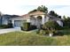 Charming single-story home boasts a well-manicured lawn and inviting curb appeal at 14112 Whitecap Ave, Hudson, FL 34667