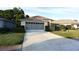 Charming single-story home with well-maintained lawn and attached garage at 14112 Whitecap Ave, Hudson, FL 34667
