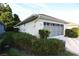 Side view of the house with attached garage and green landscaping at 14112 Whitecap Ave, Hudson, FL 34667