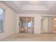 Open living room features access to the sunroom and mirrored closet doors, offering flexibility and space at 14112 Whitecap Ave, Hudson, FL 34667