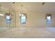 Spacious living room featuring neutral carpet and windows with decorative valances at 14112 Whitecap Ave, Hudson, FL 34667