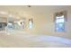 Spacious living room with carpet flooring and a large window with decor at 14112 Whitecap Ave, Hudson, FL 34667