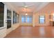 Light-filled sunroom with wood floors and windows surrounding the space at 14112 Whitecap Ave, Hudson, FL 34667