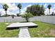 The backyard features a white fence, tropical palm trees and a deck with walkway at 15160 Durango Cir, Brooksville, FL 34604