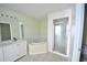 Bright bathroom featuring a soaking tub, and separate shower stall at 15160 Durango Cir, Brooksville, FL 34604