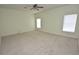 Spacious bedroom featuring neutral walls, carpet flooring, ceiling fan, and lots of natural light at 15160 Durango Cir, Brooksville, FL 34604
