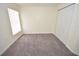 Bedroom featuring neutral walls, carpeting, a closet, and natural light from the window at 15160 Durango Cir, Brooksville, FL 34604
