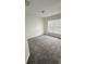 Cozy bedroom featuring neutral walls, carpeting, and a bright window with blinds at 15160 Durango Cir, Brooksville, FL 34604