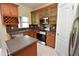 Cozy kitchen features wooden cabinets, stainless steel appliances, and a handy center island at 15160 Durango Cir, Brooksville, FL 34604