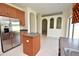 Spacious kitchen featuring stainless steel refrigerator and a functional island with breakfast bar at 15160 Durango Cir, Brooksville, FL 34604