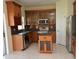 This kitchen includes wood cabinets, stainless steel appliances, and a practical center island at 15160 Durango Cir, Brooksville, FL 34604