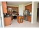 Well-lit kitchen boasts stainless steel appliances, tile flooring, and a functional center island at 15160 Durango Cir, Brooksville, FL 34604