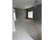 Spacious living room with neutral-colored walls, carpeted floor, window, and chandelier at 15160 Durango Cir, Brooksville, FL 34604
