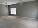 Spacious living room with neutral-colored walls, carpeted floor, window, and chandelier at 15160 Durango Cir, Brooksville, FL 34604