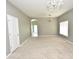 Bright living room featuring neutral carpet, chandelier lighting and open floorplan at 15160 Durango Cir, Brooksville, FL 34604