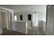 Hallway includes multiple doorways, wood floors, and neutral paint at 15160 Durango Cir, Brooksville, FL 34604