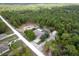 An aerial view shows a single-Gathering home nestled among the trees with a pool and detached shed at 15287 Coot Rd, Weeki Wachee, FL 34614