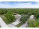 Aerial view of a single Gathering home with a pool, shed and an attached two car garage surrounded by lush forest at 15287 Coot Rd, Weeki Wachee, FL 34614