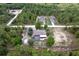 Aerial view of house with screened pool in backyard surrounded by trees at 15287 Coot Rd, Weeki Wachee, FL 34614