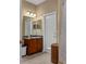 Bathroom featuring a vanity with granite countertops, mirrored accents, and a decorative woven basket at 15287 Coot Rd, Weeki Wachee, FL 34614