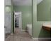 Ensuite bathroom with a walk-in closet, soaking tub, and neutral green walls at 15287 Coot Rd, Weeki Wachee, FL 34614