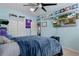 Bedroom with a TV, large closet, and a comfortable bed under a ceiling fan, creating a cozy retreat at 15287 Coot Rd, Weeki Wachee, FL 34614