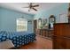 This bedroom features natural light, wood-look flooring, and a matching wood dresser with TV at 15287 Coot Rd, Weeki Wachee, FL 34614