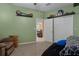 Bedroom showcasing a cozy seating area, wall decor, and a glimpse into a nearby room at 15287 Coot Rd, Weeki Wachee, FL 34614