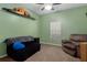 Cozy bedroom featuring a ceiling fan, decor, sofa, and comfortable seating for relaxation and leisure at 15287 Coot Rd, Weeki Wachee, FL 34614